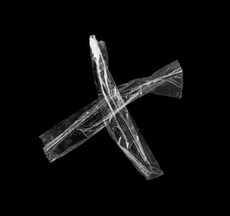 adhesive plastic tape isolated on black backgroundの写真素材