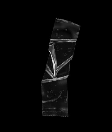 adhesive plastic tape isolated on black backgroundの写真素材