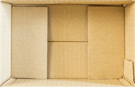 Open empty brown cardboard box background top viewの写真素材