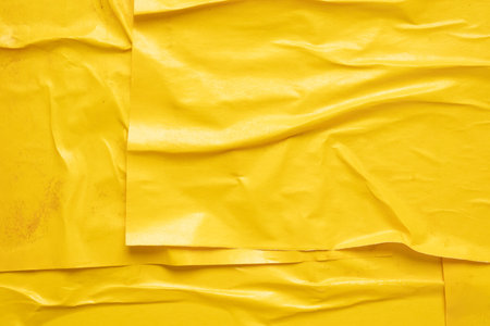 Blank yellow crumpled and creased paper poster texture backgroundの写真素材
