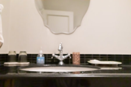Abstract blur white sink and faucet bathroom interior backgroundの写真素材