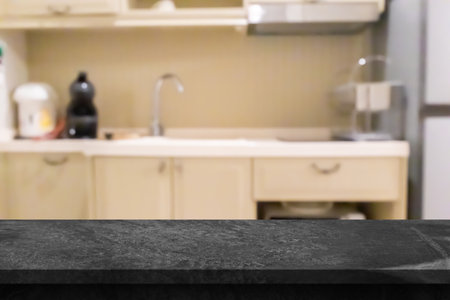 Black marble stone counter top with blurred kitchen backgroundの写真素材