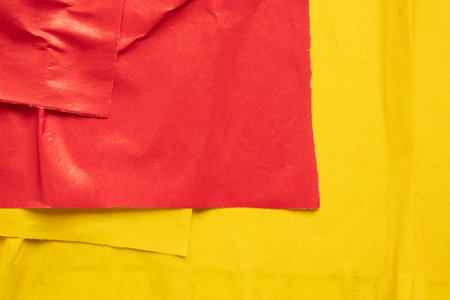 Blank red and yellow crumpled and creased paper poster texture backgroundの写真素材