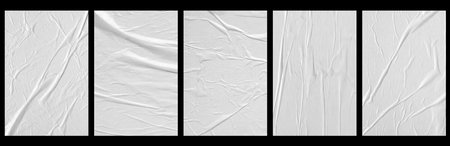 white crumpled and creased glued paper poster set isolated on black backgroundの写真素材
