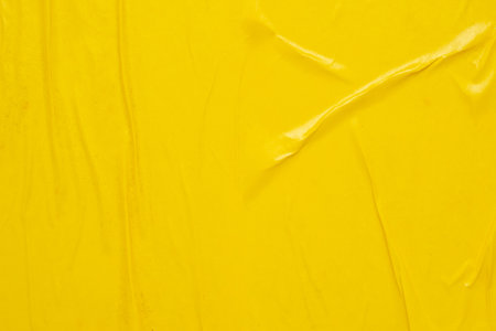 Blank yellow crumpled and creased paper poster texture backgroundの写真素材