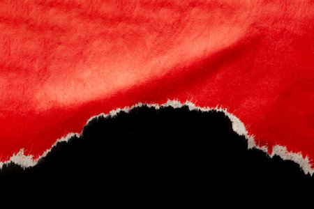 Red ripped paper torn edges strips isolated on black backgroundの写真素材