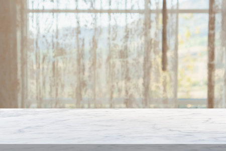 Empty marble table top with window curtain abstract blur background for product displayの写真素材