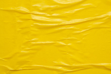 Blank yellow crumpled and creased paper poster texture background