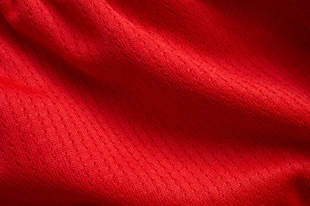 Red sports clothing fabric football shirt jersey texture backgroundの写真素材