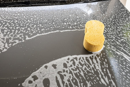 car cleaning and washing with yellow sponge and foam soapの写真素材