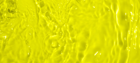 Abstract transparent water shadow surface texture natural ripple on yellow backgroundの写真素材