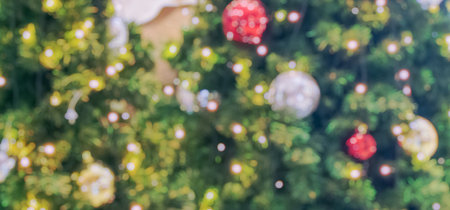 Abstract blurred christmas tree with bokeh light backgroundの写真素材