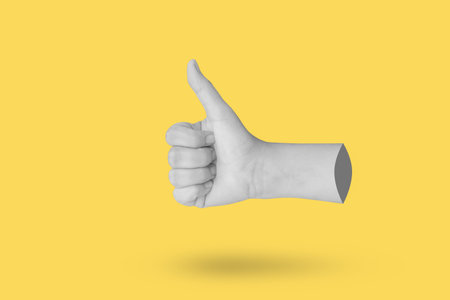 Woman hand gesture thumb up sign isolated on yellow background