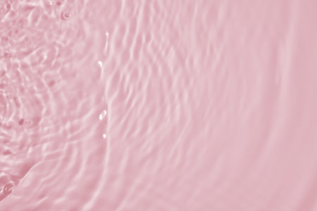 Abstract transparent water shadow surface texture natural ripple on pink backgroundの写真素材