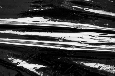 Black transparent plastic film wrap overlay texture backgroundの写真素材