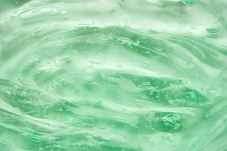 Transparent clear green liquid serum gel cosmetic texture background