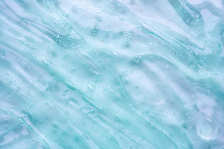 Transparent clear blue liquid serum gel cosmetic texture background
