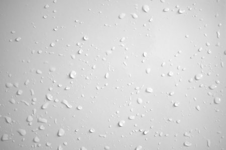 Water drops on white wall background textureの写真素材