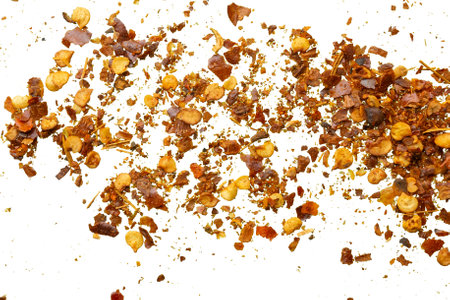dried red chili pepper flakes and seeds isolated on white background top viewの写真素材