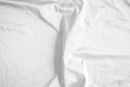 Abstract white wrinkled bedding sheet fabric texture backgroundの写真素材