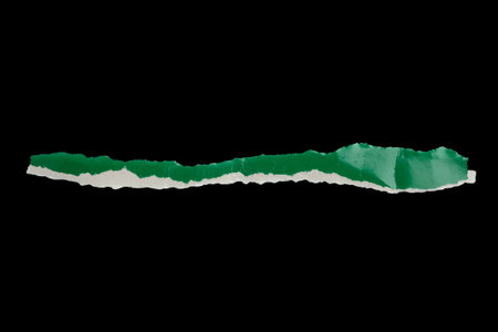 piece of green paper tear isolated on black backgroundの写真素材