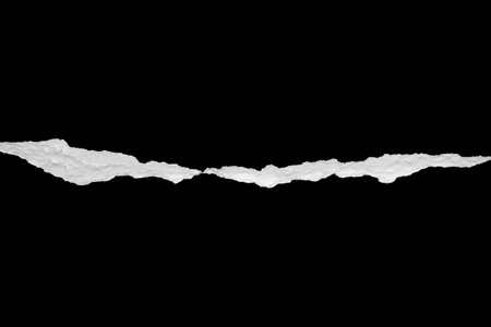 Ripped torn paper edges isolated on black backgroundの写真素材