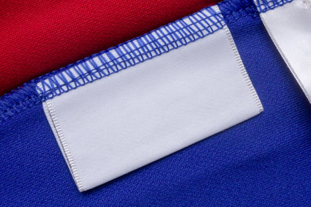 White blank laundry care clothes label on blue shirt fabric backgroundの写真素材