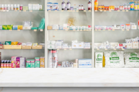 Empty white marble counter top with blur pharmacy drugstore shelves backgroundの写真素材