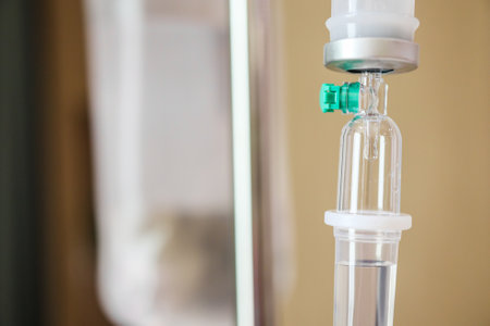 Close up medical intravenous IV drip in hospital backgroundの写真素材