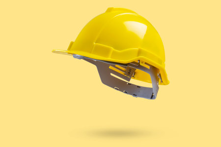 Safety construction helmet on yellow backgroundの写真素材