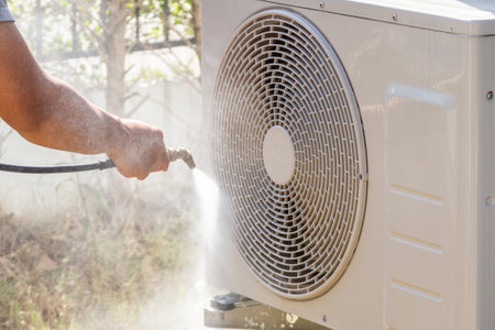air conditioning compressor outdoor unit cleaning service with water sprayの写真素材
