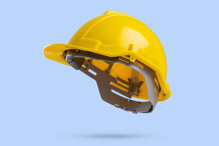 Yellow safety construction helmet on blue backgroundの写真素材