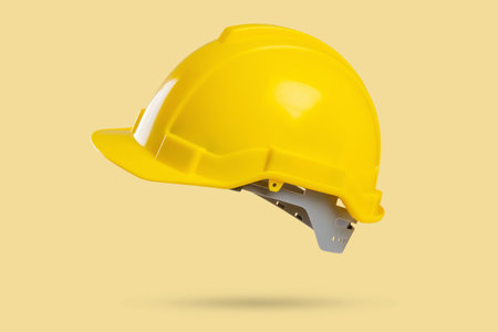 Safety construction helmet on yellow backgroundの写真素材