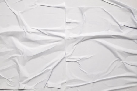 white crumpled and creased glued wrinkled paper poster texture backgroundの写真素材