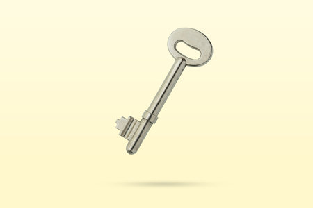 Old silver house key float on backgroundの写真素材