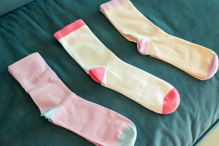 Colorful cotton sport socks on blue sofa backgroundの写真素材