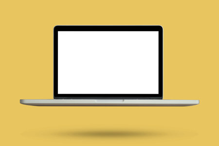 Laptop with blank screen isolated on yellow backgroundの写真素材