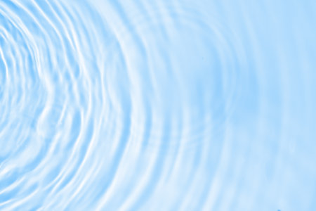 Abstract transparent water shadow surface texture natural ripple on blue backgroundの写真素材