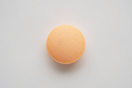 Orange medicine pill tablet on white backgroundの写真素材