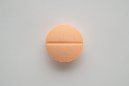 Orange medicine pill tablet on white backgroundの写真素材