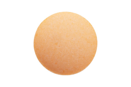 Orange medicine pill tablet isolated on white backgroundの写真素材