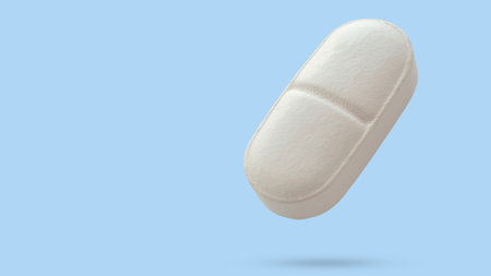 White medicine pill tablet float on blue backgroundの写真素材