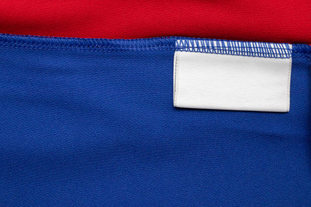White blank laundry care clothes label on shirt fabric backgroundの写真素材