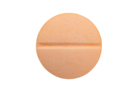 Orange medicine pill tablet isolated on white backgroundの写真素材