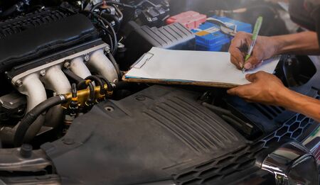 Mechanic check the car engine auto repairの写真素材