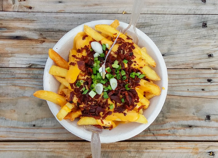 french fried cheese with fried bacon on wooden tableの写真素材