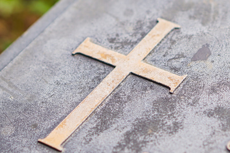 Cross on stone (selective focus)