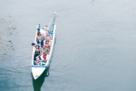 Kanchanaburi,Thailand - July 2016;travelers in motor boat on Kwai river in Kanchanaburi (cool tones)のeditorial素材