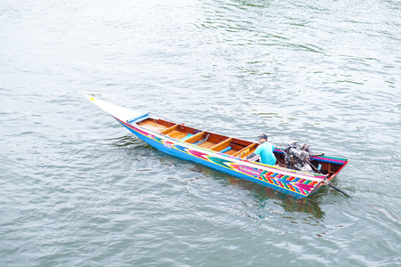 Kanchanaburi,Thailand - July 2016;boat driver in traditional Thai boat on Kwai riverのeditorial素材