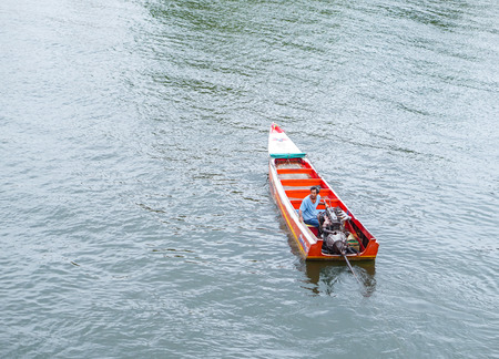 Kanchanaburi,Thailand - July 2016;boat driver in traditional Thai boat on Kwai riverのeditorial素材